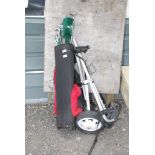 Part set of golf clubs with wheeled trolley