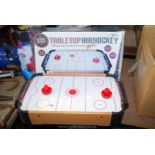 A boxed small air hockey game.