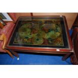 A glazed topped coffee table with a map of the world inserted (frame a/f.), 33" x 41" x 18" high.