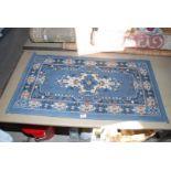 Small blue and ivory hearth rug, 43" x 24".