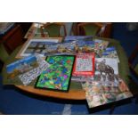 A box of framed and mounted jigsaw puzzles.