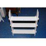 A painted set of wooden peg end shelves, 27" high x 26" wide x 6" deep.