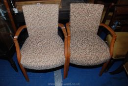 A pair of sprung and upholstered armchairs.