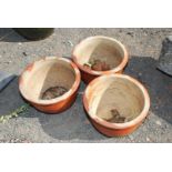 Three glazed garden planters, 15'' wide x 10'' high with stands, one with small chip.