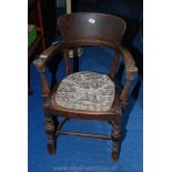 An oak armchair with bentwood leg base.