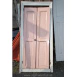 Pair of painted softwood doors complete with frame, overall, 33'' wide x 73'' high.