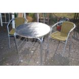 Two cane style garden chairs and a metal table (top recovered)