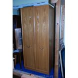 A tall two door wardrobe, 80" high x 36" wide x 23" deep.