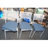 Three pierced metal garden chairs with extra cushions