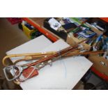 A bundle of walking sticks and shooting sticks, some hand made.