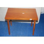 A teak occasional table, 26" long x 18" wide x 20" high.