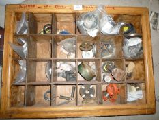 A pigeon-hole storage shelf unit containing a good quantity of mixed new spare parts including