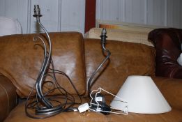 Two modern metal table lamps, one having a shade.