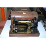 A wooden cased Singer hand Sewing machine,