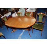 A teak round ended dining table, 42" wide x 62" long with four matching green velvet chairs.