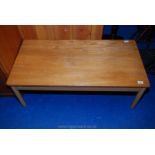 A light coloured wooden coffee table 21" wide x 42" long x 15" high.