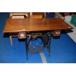 A Singer treadle sewing machine base with replacement top 48" long x 20 1/2" wide x 30" high.