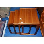 A nest of three teak tables.