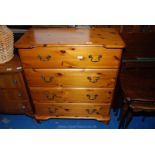 A four drawer pine chest of drawers 37" high x 33" long x 17" deep.