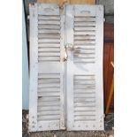 Pair of French chateau style window shutters, 59'' high x 34'' wide (some small damage).