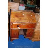 A writing bureau with a dog kennel centre (one knob detached).