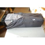 A cased travel Cot