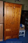 A modern pine two door wardrobe, 72" high x 32" wide x 21" deep.