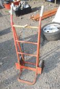 Red coloured sack truck with solid tyres