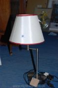 A chrome adjustable reading lamp.