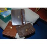 Three various leather brief cases.