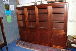 A hardwood four glazed door over four door cupboard lounge unit, 80" long x 63" high x 13 1/2" deep.