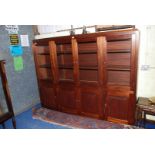 A hardwood four glazed door over four door cupboard lounge unit, 80" long x 63" high x 13 1/2" deep.