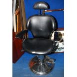 A faux leather Barbers Chair on a circular chrome base.