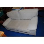 A two seat sofa with removable arm covers and cushions.