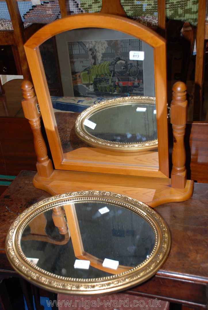 A pine swivel top dressing table mirror plus a gut framed oval mirror.