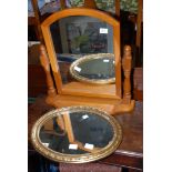 A pine swivel top dressing table mirror plus a gut framed oval mirror.