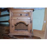 A pine cupboard with drawer and slatted cupboard door, 26" high x 19" deep x 23" wide.