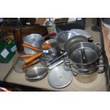 A large quantity of saucepans and three tier steamer, frying pans etc.
