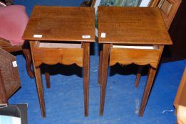 A pair of oak occasional tables with drawers, 24" high x 14" wide x 14" deep.