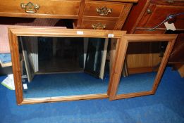 Two pine framed mirrors; one 56 cm x 70 cm and the other 44 cm x 58 cm.