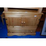 A pine two door cupboard with lower drawer 34" long x 17" wide x 28" high.