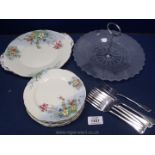 A glass cake stand and forks and hand painted tea time plates made by Aynsley.