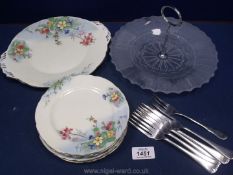 A glass cake stand and forks and hand painted tea time plates made by Aynsley.