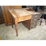 A Pine clerk's Desk having lift-up sloping lid similar to a school desk to the left hand side,