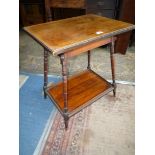 An Edwardian Rosewood rectangular Occasional Table in the arts and crafts style with sloping turned