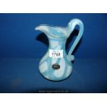 A glass Jug from Langsworthy, Cornwall, light blue swirls, 6" tall.