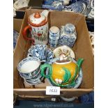 A quantity of oriental china including orange and white teapot, yellow and green teapot,