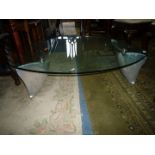 A low glass topped Lounge Table with polished aluminium shark shaped feet and curved sides,