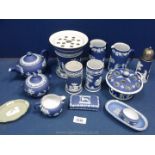 A quantity of dark blue Wedgwood Jasperware including a rose bowl, teapot, jugs, sugar sifter etc.