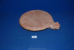 An old Indian red sandstone chapati board,